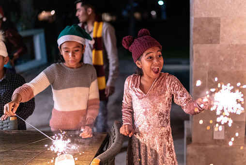 Sisters celebrating christmas with sparklers