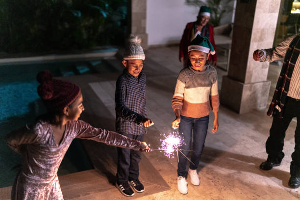 istock Siblings playing on christmas with sparklers outdoors 1425615588