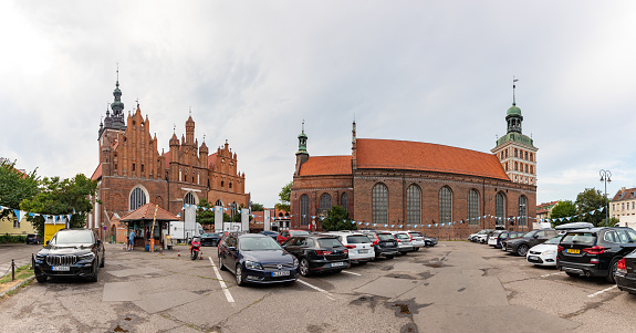 Gdansk, Poland - August 15, 2022: A picture of the St. Catherine's Church and the St. Bridget's Church in Gdansk, as seen from a parking lot.