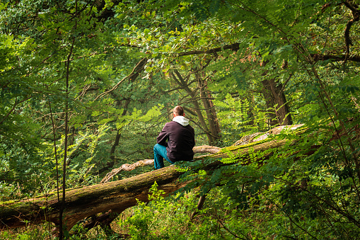 Photo of a senior man who enjoys being outdoors, in nature, on a lovely autumn day and also enjoying his golden years