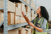 Logistics, checklist and woman in delivery supply chain warehouse factory for shipping stock, products and boxes. Industrial, freight and distribution industry worker working in courier storage plant