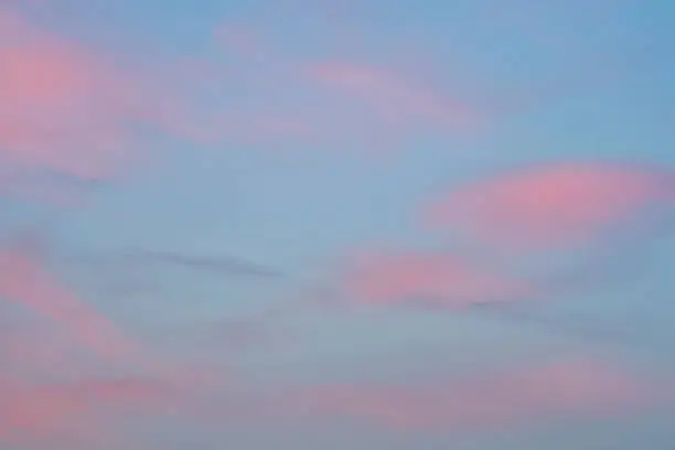 Blue sky with pink and gray clouds just before sunrise. Nature background