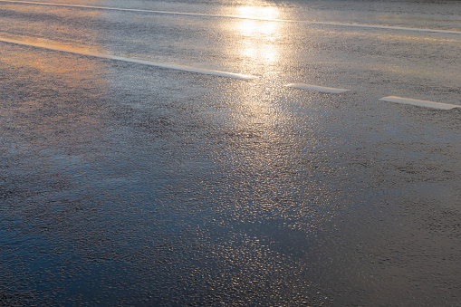 Wet asphalt road with light reflection just after rain. Background image
