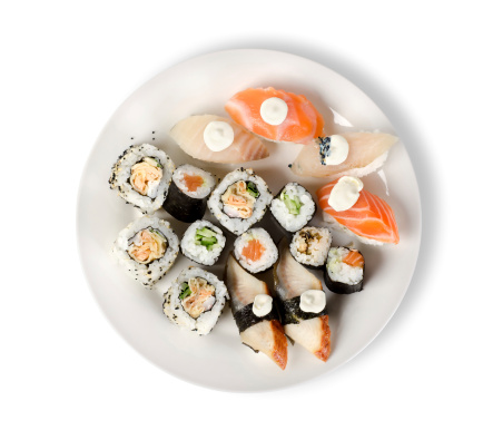 Sushi and rolls in a plate with sticks isolated on a white background. Clipping path
