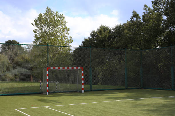 istock Red white goal soccer field made of artificial grass background 1425622112