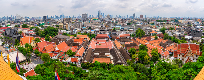 cityscape with skyscrapers and temple complex of Wat Saket or Golden Mountain Bangkok, Thailand.