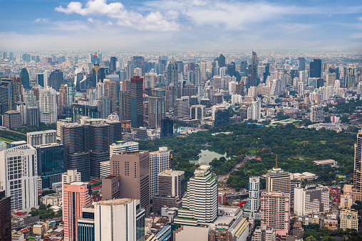 aerial view of Lumphini Park surrounded by skyscrapers In Bangkok, Thailand