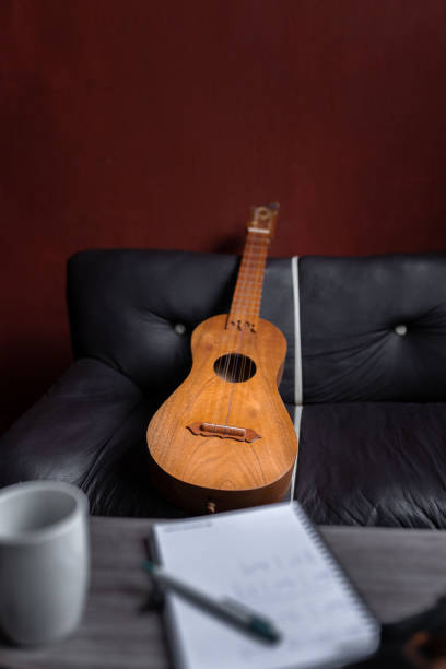 istock A Mexican jarana guitar is resting on a couch behind a composer notebook 1425625102