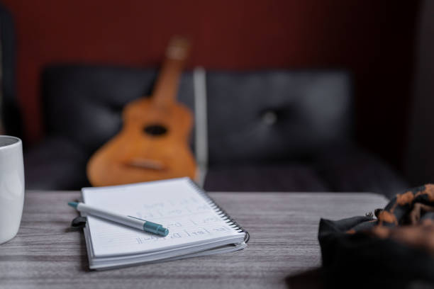 istock A notebook with music chords is resting on a table with a Mexican jarana guitar in the background 1425625206
