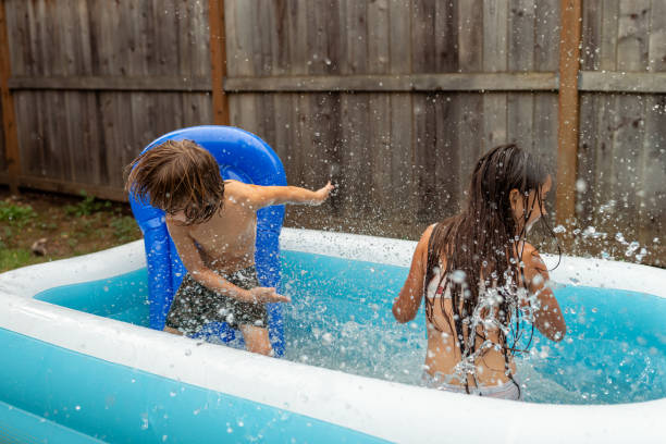 istock Ethnic Siblings Playing And Splashing In The Pool! 1425634031