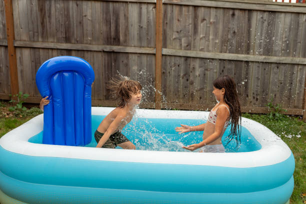 istock Ethnic Siblings Playing And Splashing In The Pool! 1425634033