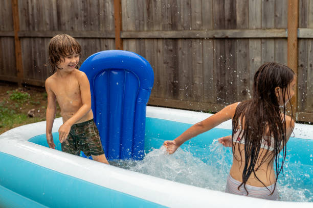 istock Ethnic Siblings Playing And Splashing In The Pool! 1425634043