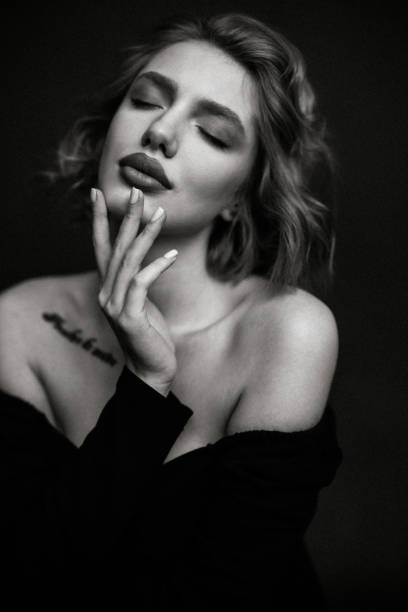 Portrait of sad blonde model with natural makeup posing at white background. Empty space
