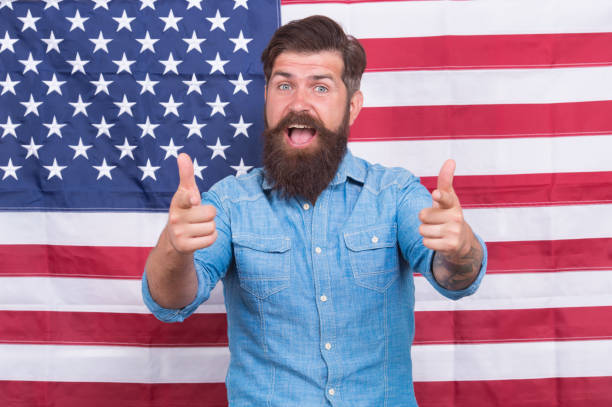 istock American man journalist reporter USA flag background, welcoming concept 1425637708
