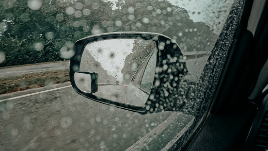 A street in Glasgow, Scotland, seen through a car windscreen on a rainy day.