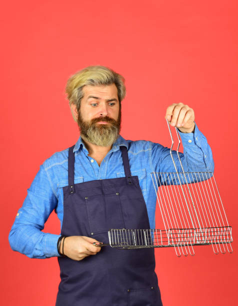 istock use cooking utensils and various products. mature chef use cooking utensils for barbecue. Tools for roasting meat. Who cook better. Ultimate cooking challenge. prepare dinner for family. Flying piece 1425638348