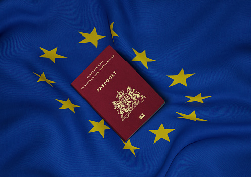 A torn EU flag blows in the wind with a few clouds in the background, seen in Pevensey Bay, East Sussex, England, UK