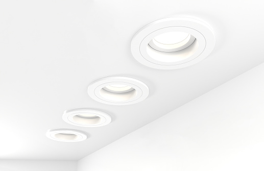 Spotlights recessed ceiling 3D render. Realistic interior room with round glowing spot lights, modern white LED lamps, downlights for home or office, artificial lighting angle view
