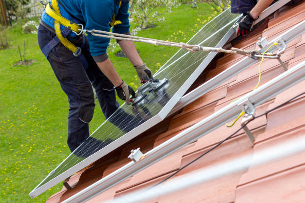 istock Workers installing solar panels on roof. Alternative energy concept. 1425642702