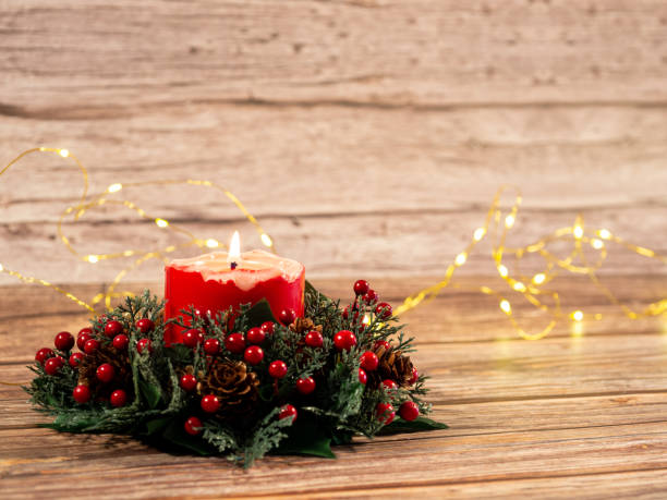 istock Christmas candles and lights  on wood background 1425646327