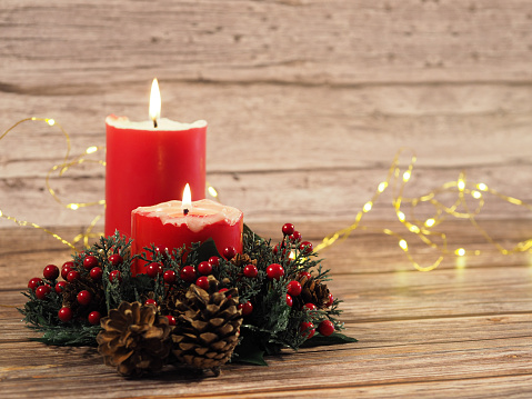 Christmas candles and lights  on wood background