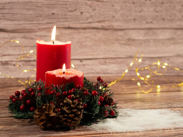 istock Christmas candles and lights  on wood background 1425646349