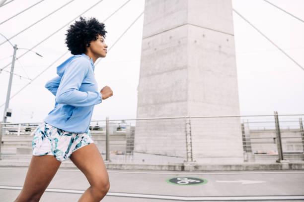 istock Woman Enjoying Run on Urban Bridge 1425649006