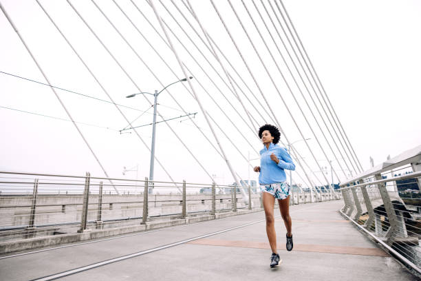 istock Woman Enjoying Run on Urban Bridge 1425649026