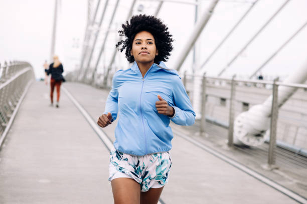 istock Woman Enjoying Run on Urban Bridge 1425649309
