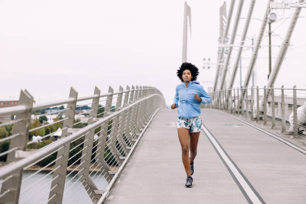istock Woman Enjoying Run on Urban Bridge 1425650076