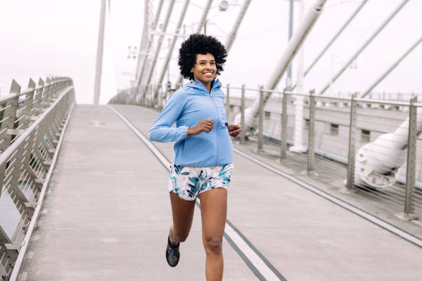 Woman Enjoying Run on Urban Bridge
