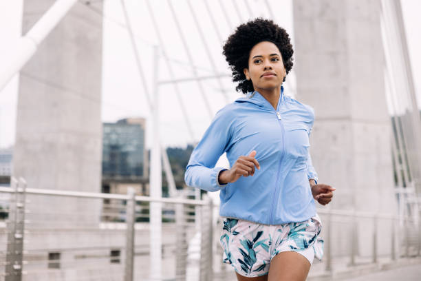 istock Woman Enjoying Run on Urban Bridge 1425650143
