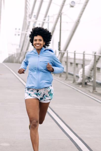 istock Woman Enjoying Run on Urban Bridge 1425650146