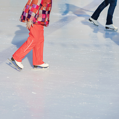 Abstract view of girl teenager on winter skate rink. Winter outdoor activity, winter sport concept