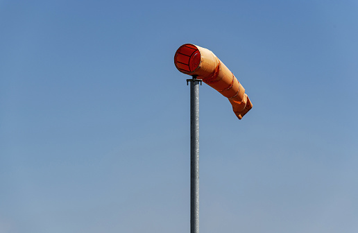 Wind sock swollen and sways in the wind on a sunny day.