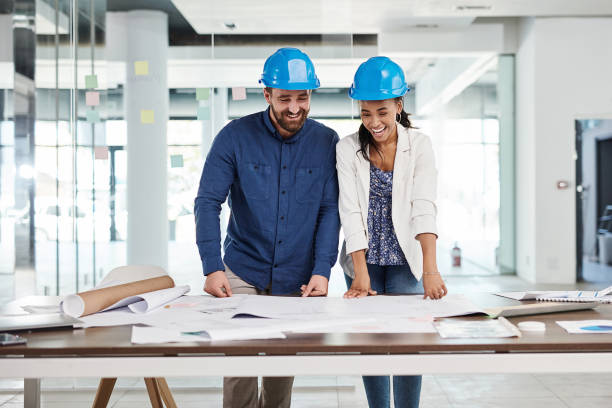 istock Engineer, architect and happy team planning, talking and excited about blueprint or building plans in office. Diversity, innovation and collaboration on architecture project ready for construction 1425656826