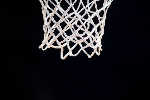 Empty swooshing basketball net close up with dark background. Professional sport concept Empty swooshing basketball net close up with dark background. Professional sport concept back board basketball stock pictures, royalty-free photos & images