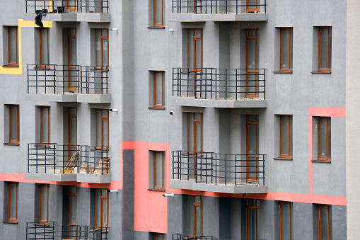 Residential building view in Berlin. Facade of a big apartment building with small balconies.