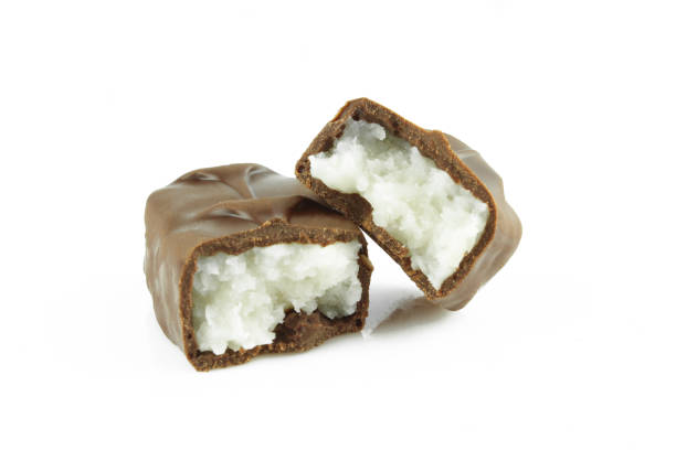 Two pieces of broken coconut filled chocolate bar isolated on white background