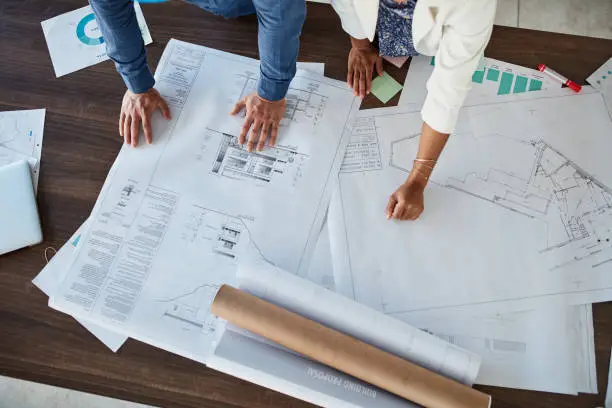 Architecture planning, development and project management business people hands with floor plan paper or charts for analysis. Teamwork, collaboration and design workers with strategy, mission or goal