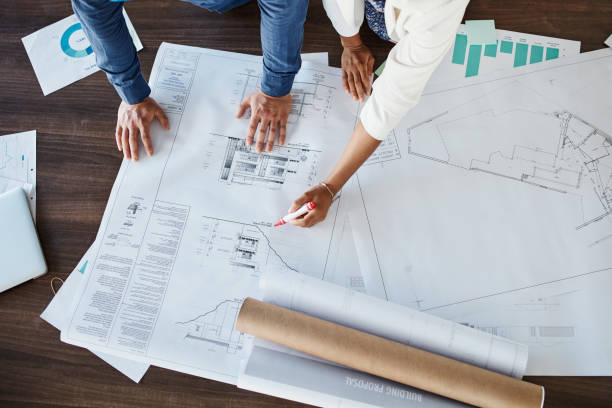 istock Blueprint hands, architecture floor plan and creative planning for building project, industrial engineering and construction. Above of property designer, contractor sketch and renovation development 1425667522