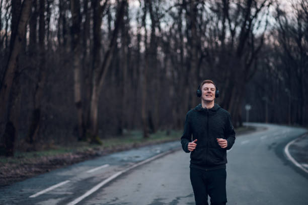 istock Redhead young man running outside on a mountain road 1425673282