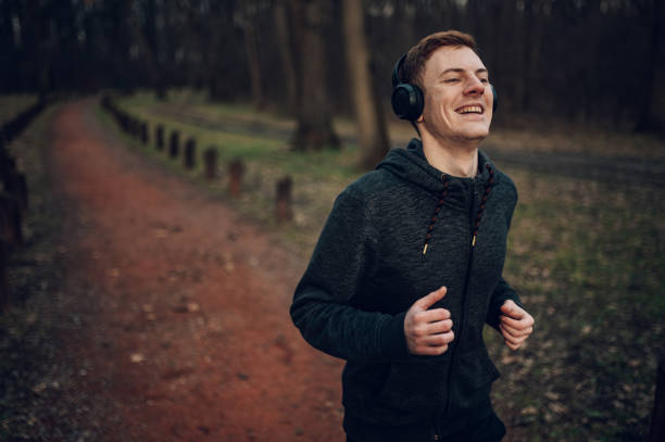 istock Young redhead man running in forest 1425673293