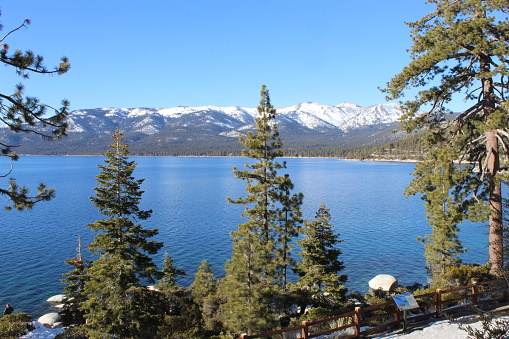 Shoreline view of snow capped mountains and Lake Tahoe