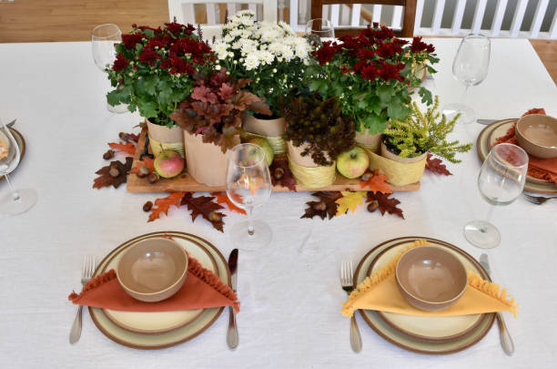 istock Fall table decor with flowering chrysanthemums, harvest apples and fall leaves 1425681701