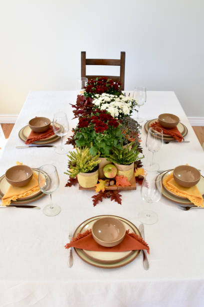 istock Fall table decor with flowering chrysanthemums, harvest apples and fall leaves 1425681719