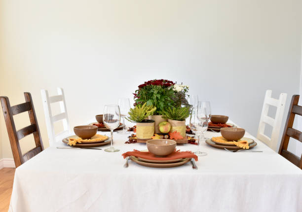 istock Fall table decor with flowering chrysanthemums, harvest apples and fall leaves 1425681730