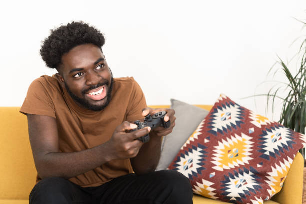 istock Man playing video games at home 1425686187