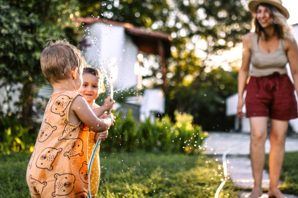 istock Family fun with garden hose in back yard 1425687720