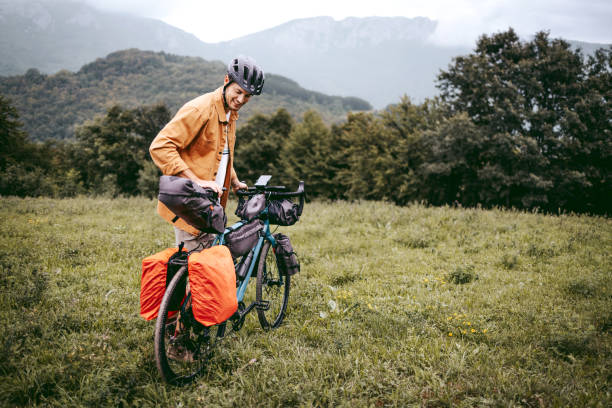 istock Young cyclist explorer with bicycle in the mountain 1425688389